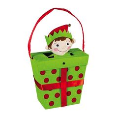 a green box with a red ribbon and a small doll in it's top