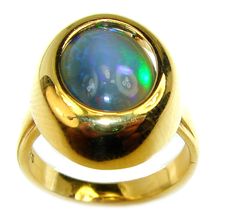 Handmade Unique 925 Sterling Silver ring with unique one of a kind Black Opal,  7.20 grams of marvelous handcrafted jewelry design. Only one piece availble ready to ship! It's unique worldwide ring - simply piece of art in world of fine jewelry. Vintage Design 9.2ctw Genuine  Black  Opal  14K Gold over .925 Sterling Silver handmade Ring size 6  RING DETAILS: Weight: 7.20g; Size: 6; Material: Sterling Silver; Main stone: Black Opal; Dimension: L - 3/4, W - 5/8, T - 3/8 inch; Stamp / Mark: 925; Co Gold Opal Ring With Polished Finish, Formal Polished Opal Ring, Formal Cabochon Opal Ring, Unique Yellow Gold Opal Ring With Polished Finish, Handmade Round Opal Ring For Formal Events, Unique Round High Luster Jewelry, Domed Hallmarked Ring For Gift, Unique High Luster Round Jewelry, Unique Round High-luster Jewelry