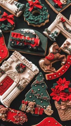 decorated cookies are arranged on a black tablecloth with red and green trimmings