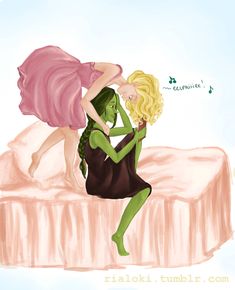 two women dressed in green and pink sitting on a bed with their arms around each other