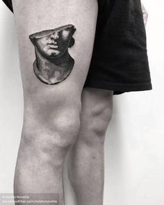 a black and white photo of a man's leg with a hat on it