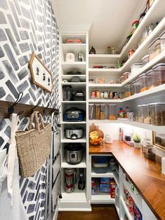 an organized pantry with lots of shelves and baskets on the counter top, along with other items