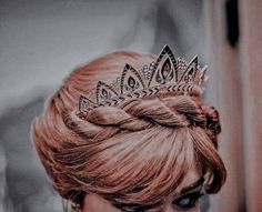 a woman with red hair wearing a tiara