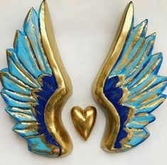 two blue and gold angel wings with a heart