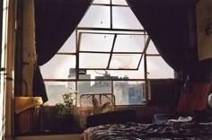 a bed sitting under a window in a bedroom