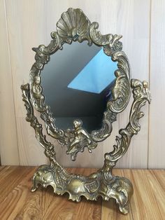 a mirror sitting on top of a wooden table