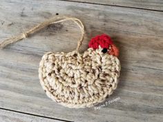 a crocheted ornament with a red rooster on it's head