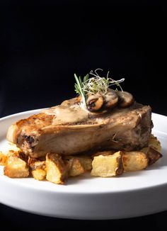 a person holding a white plate with food on it