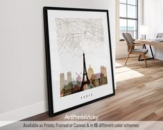 an art print hangs on the wall next to a desk and chair in front of a window