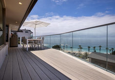 an outdoor deck overlooking the ocean and beach