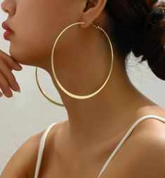 Upgrade your style with our Oversized Hoop Earrings. These hoops are not just fashionably large, but also make a statement. Made with high-quality materials, they are lightweight and comfortable for all-day wear. Elevate any outfit with these trendy yet timeless earrings.