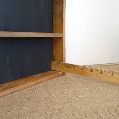 a wooden shelf with a measuring tape next to it