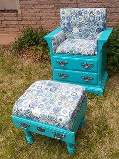 a blue chair and ottoman sitting in the grass