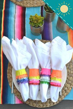 colorful napkins are sitting on a woven plate