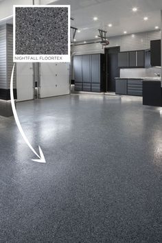 the inside of a garage with an arrow pointing to the floor and cabinets in it