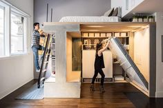 two people are working on a loft bed