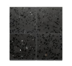 black and white marble tiles with small holes in the middle, on top of each other