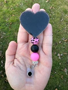 "Black glitter badge reel with coordinating pink leopard beads. The heart measures 2\" across. This badge comes with a retractable badge reel and an alligator clip." Nurse Badge Reel, Nurse Badge, Retractable Badge Reel, All That Glitters, Pink Leopard, Black Glitter, Badge Holders Lanyard, Badge Holders, Badge Reel