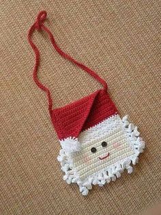 an ornament made to look like santa claus is hanging from a red string