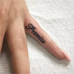 a person's hand with a small tattoo on it that says, momie