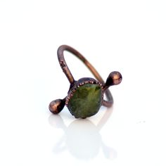 GemFormingStudio D E T A I L S Green Peridot ring | Raw peridot ring | Copper & peridot ring | Electroformed jewelry | Organic stone jewelry | Gemstone Ring, Handmade Ring Ring Size: US : All Sizes Available Gemstone : 11 X 10 MM Weight : 3.00 gm Material : Copper Polish : Copper Antique Polish . Contact us for wholesale prices. R I N G S https://www.etsy.com/in-en/shop/GemFormingStudio?section_id=22783374 B E A D S https://www.etsy.com/in-en/shop/GemFormingStudio?section_id=22828835 W A N D Minimalist Untreated Open Ring, Minimalist Adjustable Green Midi Rings, Handmade Peridot Rings As Gift, Handmade Peridot Rings For Gift, Handmade Green Toe Ring, Minimalist Handmade Green Ring, Unique Adjustable Green Stackable Rings, Handmade Adjustable Emerald Promise Ring, Unique Handmade Green Stackable Rings