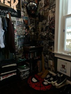 a room filled with lots of clutter next to a wall covered in posters and pictures