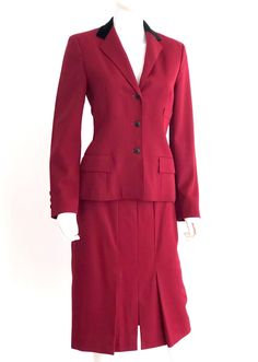 "Vintage 1980s Brass Ltd. By Don Simonelli 100% wool skirt suit in burgundy from New York's Bonwit Teller, featuring a tailored jacket with a black velvet collar, 3 front pockets, and 3 button closure; and a below knee length skirt with front bottom pleating, a kick pleat slit, and a zipper and button closure. Fully lined. Approximate Measurements: Jacket: Chest: 36\"; Waist: 33\"; Hips: 38\"; Length: 24 1/2\" Skirt: Waist: 26\"; Hips: 39\"; Length: 27 1/2\" Labeled a Size 6 Circa 1980s, skirt s Dark Red Jacket, Velvet Collar, White Plains, Kick Pleat, Wool Skirt, Front Bottoms, Wool Skirts, Tailored Jacket, Knee Length Skirt