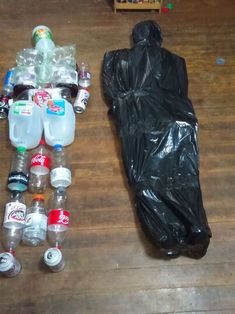 there are many bottles and plastic bags on the floor next to each other, including one with a sleeping bag