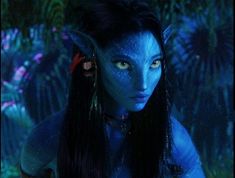 a woman with blue makeup and long hair