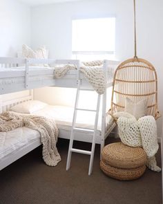 a bedroom with two bunk beds and a hammock hanging from the ceiling