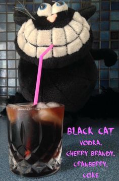 a black cat drink with a pink straw in it