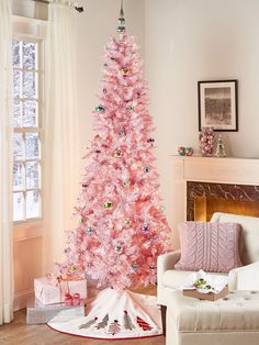 a pink christmas tree in a living room