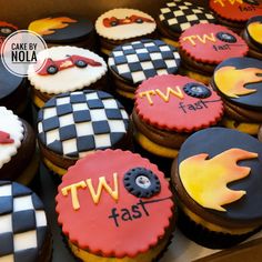 cupcakes decorated with racing themed icing and the words tw fast on them