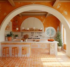 an orange and white kitchen is shown with stools on the counter, and potted plants