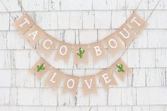 a sign that says,'taco bout love'hanging on the side of a building