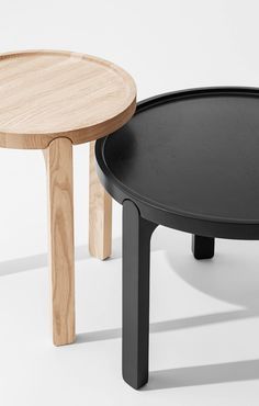 two black and wooden tables sitting next to each other