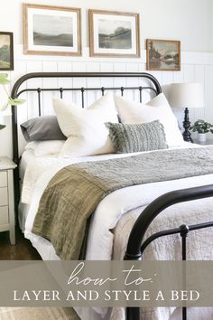 a bed with white linens and pillows in a small room next to two pictures on the wall