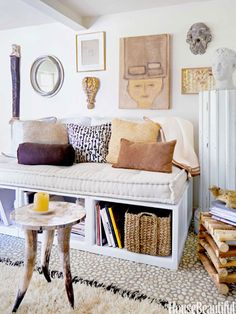 a living room filled with lots of furniture and books on top of a white shelf