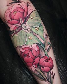 a woman's leg with flowers and a butterfly on it