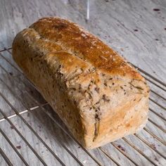 a loaf of bread sitting on top of a metal rack