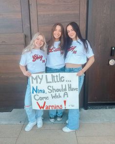 two girls holding a sign that says my little ninja should have come with a warning