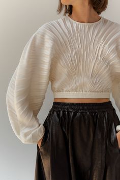 Hand pleated top in mid-weight stretch crepe. Sunburst pleats are crushed by hand to create texture. Crew neck with back keyhole closure and elasticated waistband and cuffs. Wear it with Maria Skirt in ivory crepe, Varo Skirt in leather or denim. Pleated Top Outfit, Wrap Top Outfit, Hand Pleating, Tulip Silhouette, Pleated Outfit, Damson Madder, Round Skirt, White Eyelet Skirt, Denim Fits