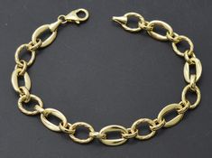 "Explore the world of luxury with this exquisite 14K Yellow Solid Gold Shiny 7.5\" Oval Texture Linked Chain Bracelet. This piece of jewelry is crafted from a solid gold oval with a rolo-linked chain, ensuring a durable and long-lasting look. Delicately designed with intricate details, this beautiful bracelet will make any day unforgettable! Sleek and timeless, this bracelet will become your favorite accessory. Discover your perfect look with this luxurious real gold piece! Specifications: Metal Gold Jewelry Bracelet, Gold Schmuck, Jewelry Bracelets Gold, Gold Armband, Gold Piece, Jewelry Bracelet, Intricate Details, Real Gold, Beautiful Bracelet