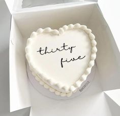 a heart shaped cake with the words thirty five written on it in a white box