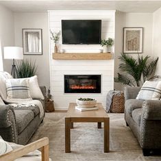 a living room filled with furniture and a flat screen tv mounted on the wall above a fire place