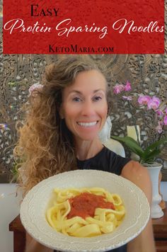 a woman holding a plate with pasta on it and the words easy protein sparing noodles