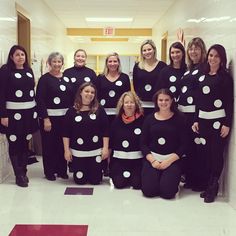 a group of women dressed in black and white polka dots