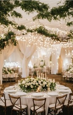 an elegant wedding reception with white flowers and greenery