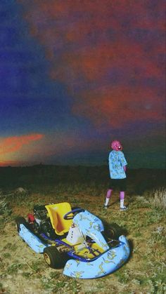 two children standing in the grass with an inflatable raft