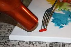 there is a fork that has been placed on a plate with paint splattered on it